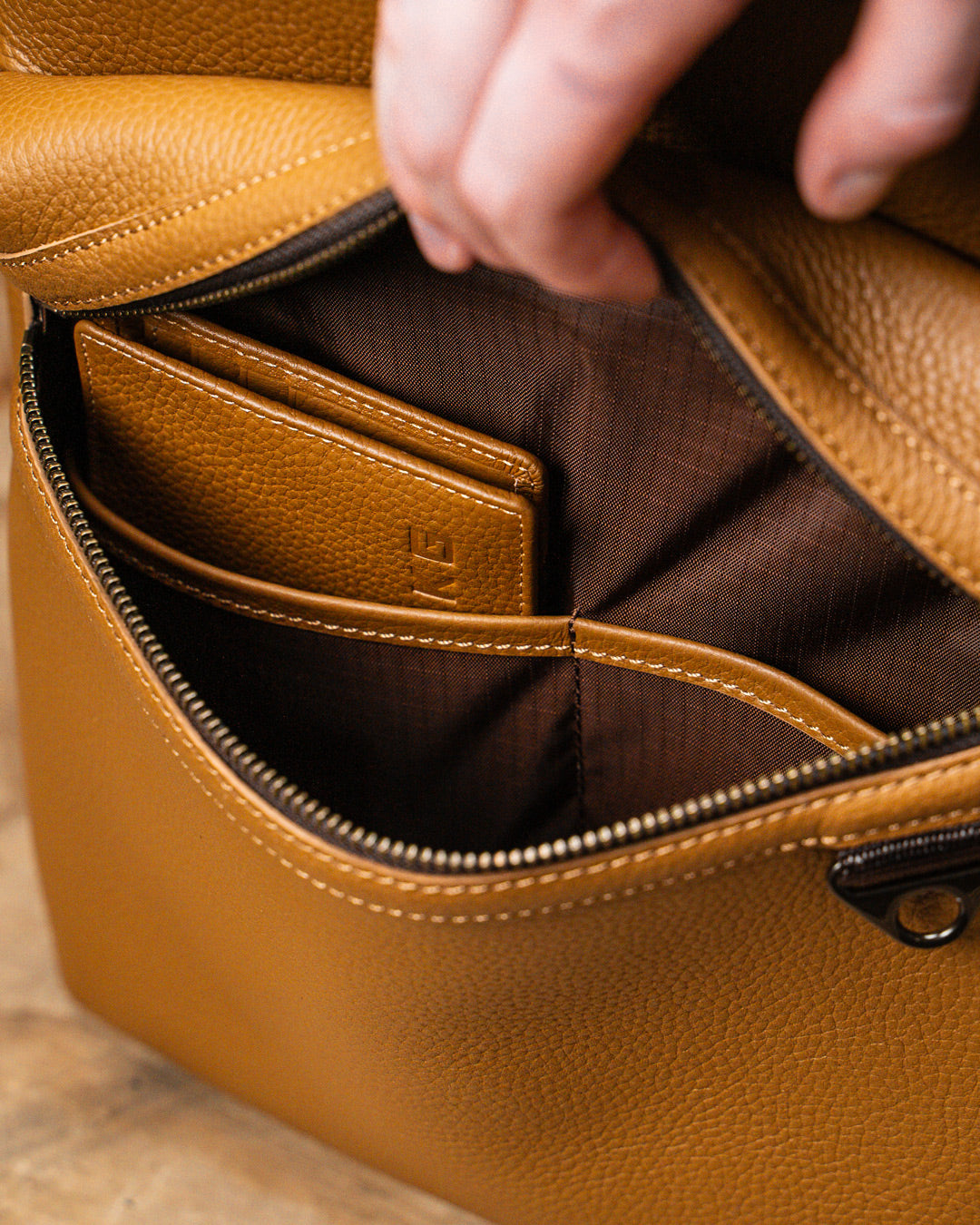 Internal view of front pocket of tan leather KNKG HERITAGE Backpack