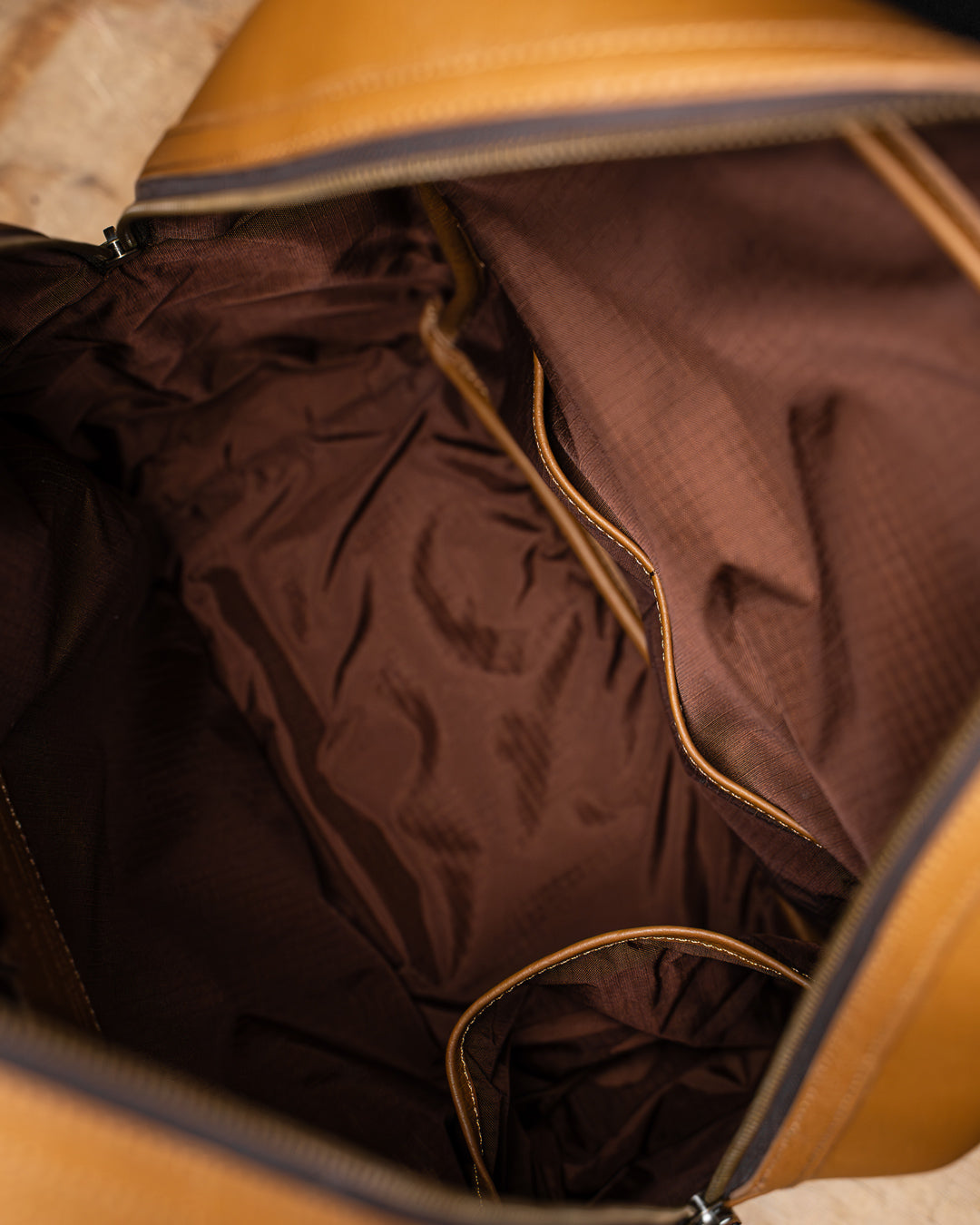 Empty internal view of tan leather KNKG HERITAGE Backpack