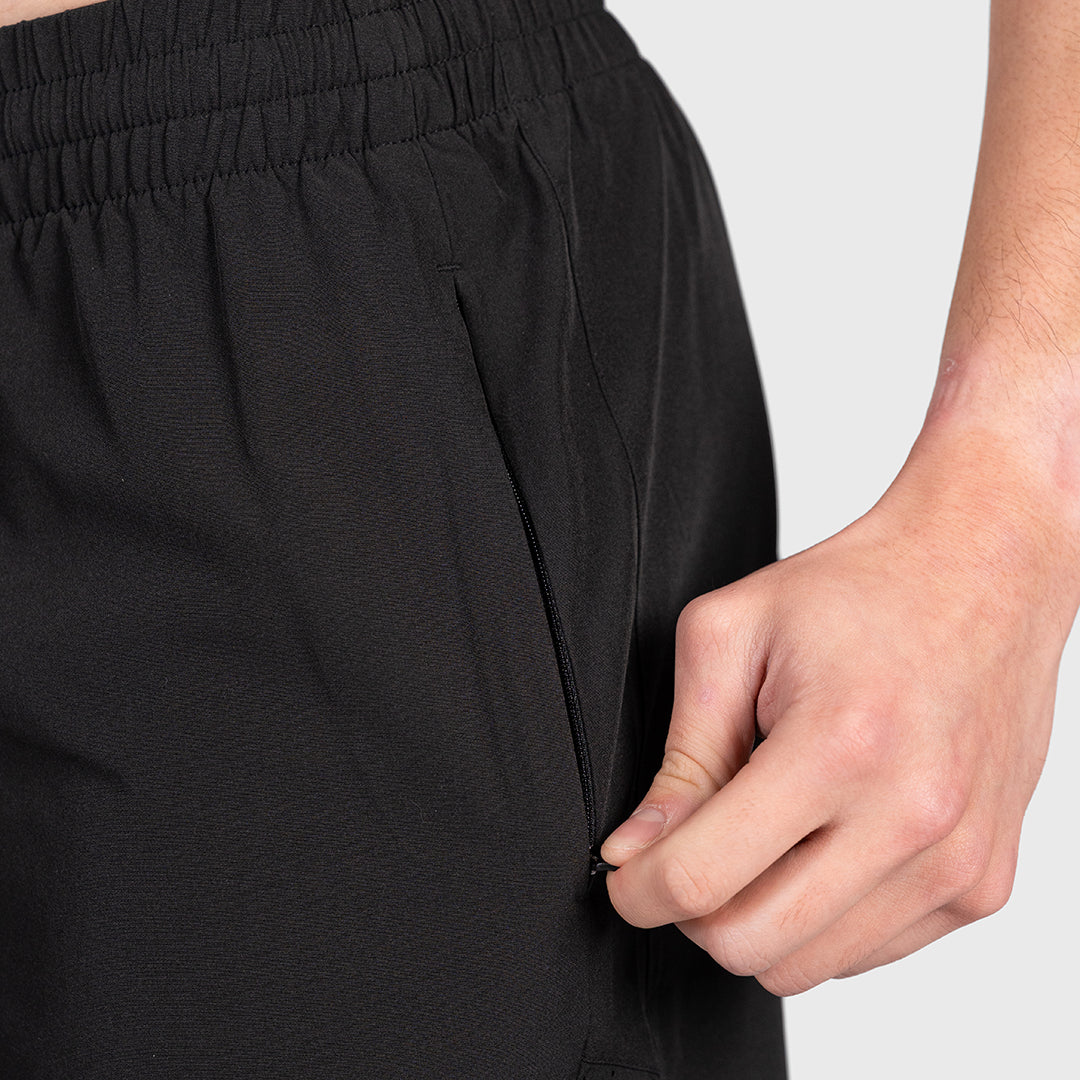 Hand accessing the zippered side pocket on the TWL Men's Rep Shorts 5" in Blackout