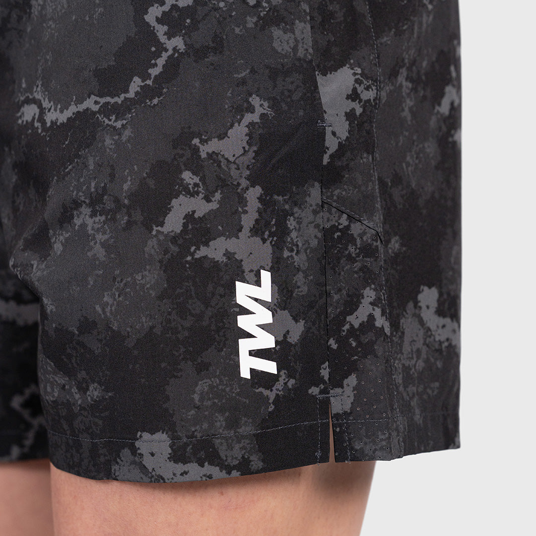 Macro detail of the side split seam and ventilation holes on the TWL Men's Rep Shorts 5" in black camo