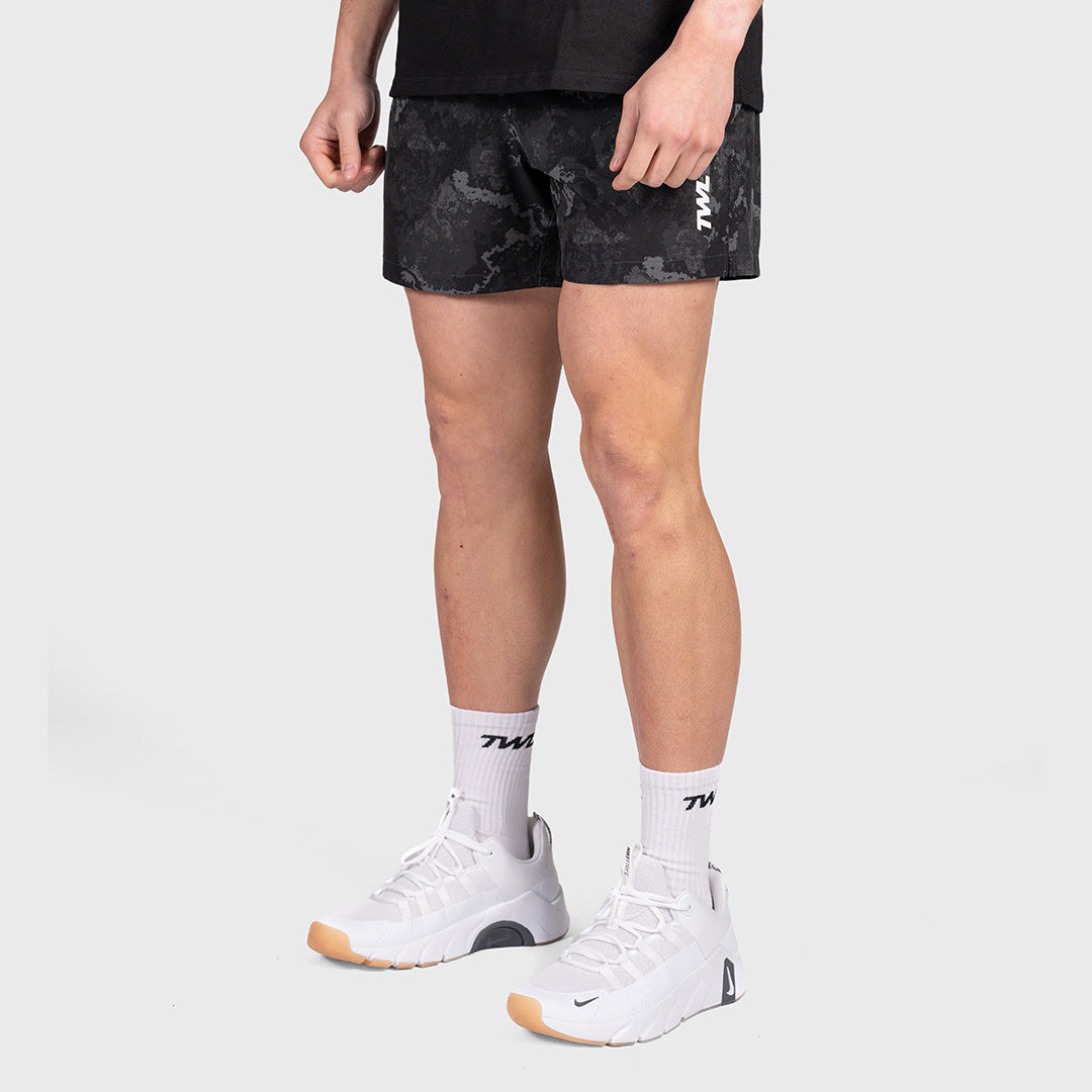 Man wearing the black camo TWL Men's Rep Shorts 5", full-length front view showing the fit