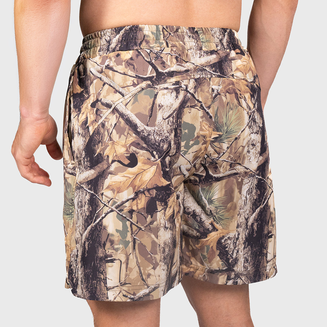 Camouflage shorts worn by a person on a plain background TWL Men's Vault Shorts 6 inch training shorts in tree camo, showing back yoke details