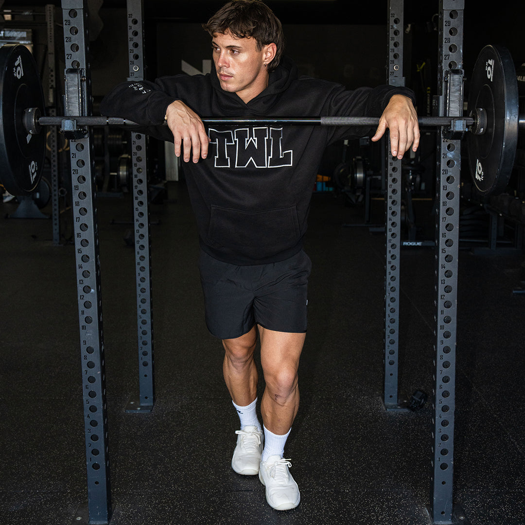 TWL Ascend Hoodie black – oversized fleece hoodie - model doing squats